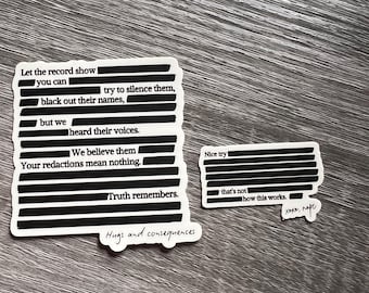 May include: Two white stickers with black text on a wooden surface. One sticker reads "Let the record show...Truth remembers." The other says "Nice try...how this works." Both have redacted text. One says "Hugs and consequences."