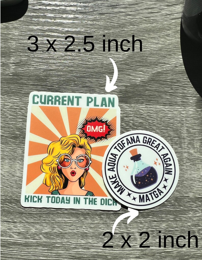 May include: Two sticker designs. The first is a 3 x 2.5 inch sticker with a retro comic book style illustration of a woman with blonde hair and large glasses. The text reads "CURRENT PLAN" and "KICK TODAY IN THE DICH". The second sticker is a 2 x 2 inch round sticker with a black background and white text that reads "MAKE AQUA TOFANA GREAT AGAIN" with a star design. The center of the sticker features a purple potion bottle with stars.