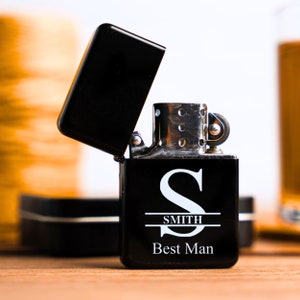 May include: Black lighter with a silver top and a white inscription that reads "S SMITH Best Man".