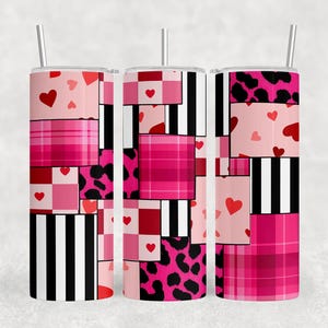 May include: Three stainless steel tumblers with lids and straws. Each tumbler features a patchwork design with pink, red, and black patterns, including hearts, plaid, and leopard print. The tumblers are designed for cold beverages.
