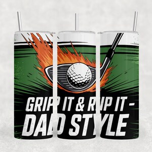 May include: Three stainless steel tumblers with straws, each with a golf-themed design. The design includes a golf ball on fire, a golf club, and the text "GRIP IT & RIP IT - DAD STYLE" in black and white.
