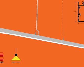 May include: A white rectangular pendant light fixture with a silver cord hanging from the ceiling. The light fixture is 1.5 inches wide and 1.5 inches tall. The image also includes the text "MADE IN USA" and "DIRECT LIGHT".