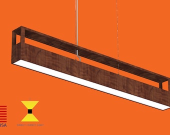 May include: A modern, rectangular pendant light fixture with a wood frame and a white LED light strip. The light fixture is suspended from the ceiling by a thin cable. The fixture is made in the USA and provides direct light.