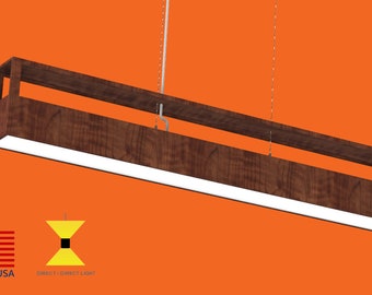 May include: A modern, rectangular pendant light fixture with a wood frame and a white LED light panel. The light is suspended from the ceiling by two thin wires. The fixture is made in the USA.  Direct / Direct Light.