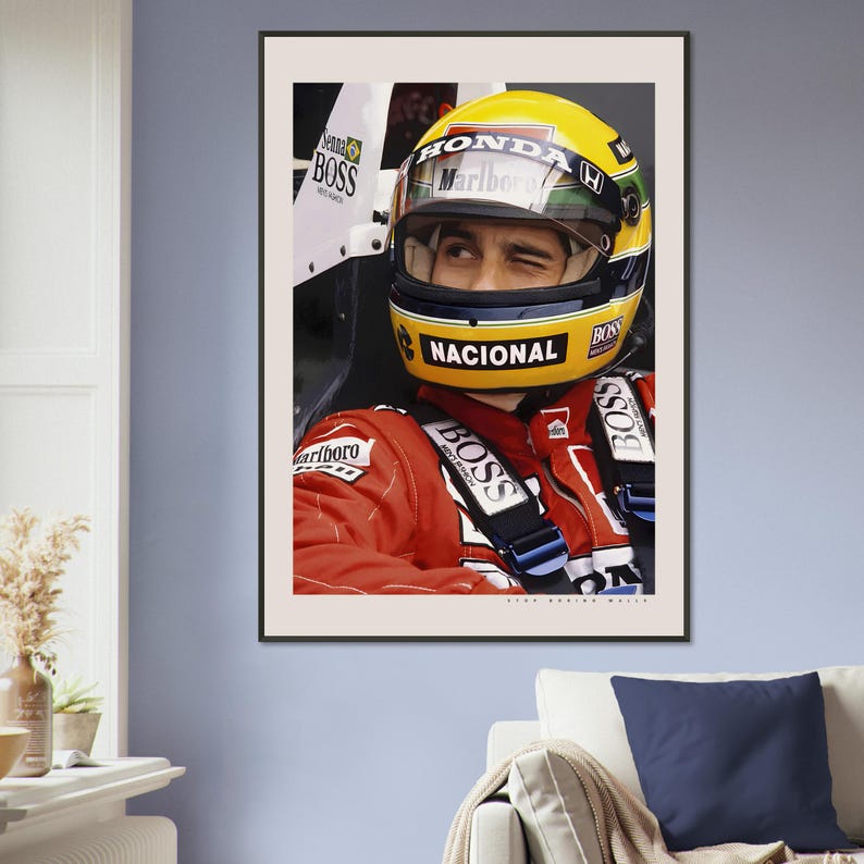 May include: A close-up of a race car driver wearing a yellow and red helmet with the word "HONDA" and "Marlboro" on it. The driver is wearing a red racing suit with the word "BOSS" on it. The driver is looking to the right.