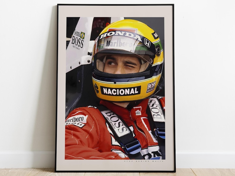 May include: A close-up of a race car driver wearing a yellow and blue helmet with the word "NACIONAL" on it. The driver is wearing a red racing suit with the word "BOSS" on it. The driver is in a race car with the word "HONDA" on it.
