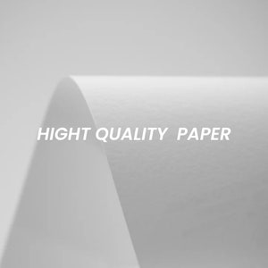 K&ouml;nnte beinhalten: Nahaufnahme eines wei&szlig;en Blattes Papier mit dem aufgedruckten Text "HIGH QUALITY PAPER".
