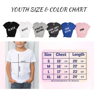 Pu&ograve; includere: Tabella delle taglie per magliette per ragazzi in vari colori, tra cui nero, bianco, grigio atletico, grigio scuro, blu reale e rosa. La tabella mostra le misure del torace e della lunghezza in pollici per le taglie S, M, L e XL.