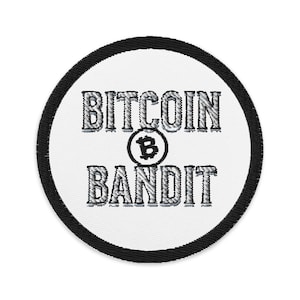May include: A white round patch with black edging. The patch has the text "Bitcoin Bandit" in a silver-grey font with a stylized Bitcoin symbol in the center.