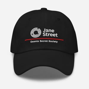 May include: Black baseball cap with the text "Jane Street" in white, above a red line and the text "Quants Secret Society". The cap features a white circular logo with a double ring design.