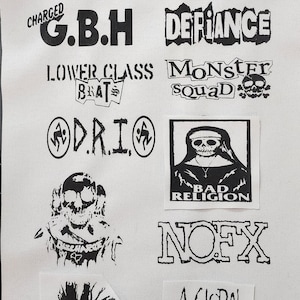 May include: A collection of black and white punk rock band patches, including "NOFX", "Bad Religion", "The Casualties", and "A Global Threat". The patches are on a white fabric background.