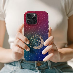 May include: A smartphone case featuring a gradient background transitioning from deep red at the top to dark blue at the bottom, covered in small white stars. A central beige crescent moon design incorporates intricate leafy branches and stars.