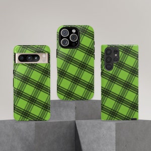 May include: Three phone cases with a green and black plaid pattern. The cases are for different phone models.
