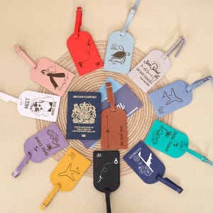 May include: A selection of travel-themed luggage tags in various colours, including red, pink, blue, green, yellow, purple, and black. The tags feature illustrations and text, alongside a British passport.