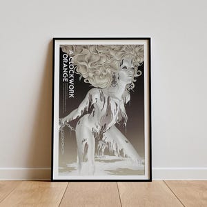May include: A black and white poster with a woman in a silver liquid. The text "A CLOCKWORK ORANGE" is printed vertically on the left side of the poster.