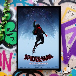 May include: A framed poster for the animated film "Spider-Man: Into the Spider-Verse." The poster features a dynamic image of Spider-Man in mid-air against a backdrop of a cityscape. The title is in red and black, with the film's tagline below.