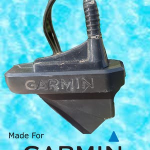 May include: Black transducer mount for a Garmin fish finder. The mount has a textured surface and the word "GARMIN" is printed on the front.