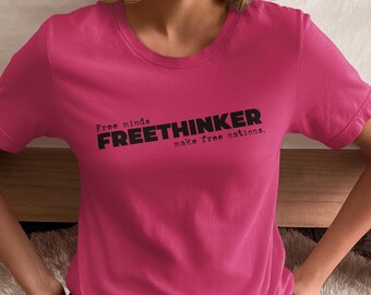 May include: A pink t-shirt with the text "Free minds FREETHINKER make free nations." printed in black.