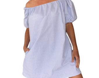 May include: A light blue and white gingham off-the-shoulder dress. The dress features short, puffed sleeves and pockets. The fabric has a classic checkered pattern. The dress is knee-length and has a relaxed fit.