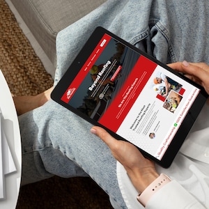 Tablet view of the ABC Roofing website template designed on Wix Studio, being used by a customer in a casual setting. This mockup highlights the mobile-friendly, touch-optimized interface ideal for clients browsing on the go. The design retains its visual appeal and user experience across devices, ensuring roofing companies can attract and engage prospects wherever they are.