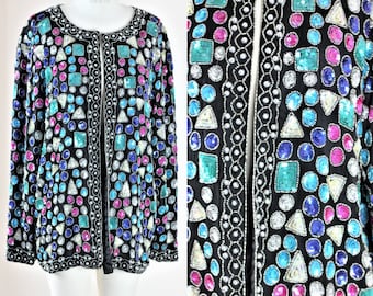 May include: A black sequined jacket with a colourful geometric pattern. The sequins are in various shapes and sizes, including circles, squares, and triangles. The jacket has a long sleeve and a front zip closure.