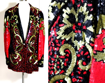 May include: A red, black and gold sequined blazer with a paisley pattern. The blazer has a single button fastening and long sleeves.