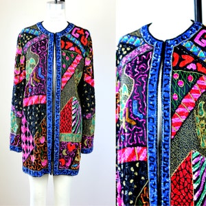 May include: A black sequined jacket with a colourful geometric pattern. The jacket has a front closure and long sleeves. The pattern includes pink, red, blue, green, and gold sequins.