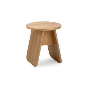 May include: A round wooden stool with a simple design. The stool has a light brown finish and a curved, A-shaped base.