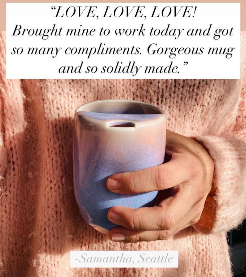 May include: A hand holding a light blue and pink ceramic mug with a unique shape. The mug has a smooth, glazed finish and a slightly rounded bottom. The caption reads: "LOVE, LOVE, LOVE! Brought mine to work today and got so many compliments. Gorgeous mug and so solidly made." -Samantha, Seattle