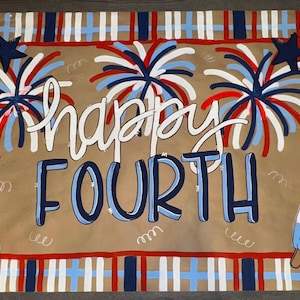 May include: A rectangular, patriotic-themed mat with the words "happy FOURTH" in white and blue. The design includes fireworks, stars, and popsicle illustrations in red, white, and blue, with a plaid border.