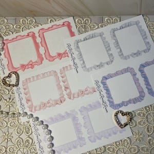 May include: A collection of decorative stickers with square frames and ruffled edges in shades of pink, blue, and purple. Each frame has a bow accent. The text "RiRi Jou Rna L Roam" is printed on the stickers.