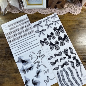 May include: Four sheets of black and white lace designs on white paper. The designs include bows, ribbons, and borders. The sheets are labeled "R&R True Pearl Room".