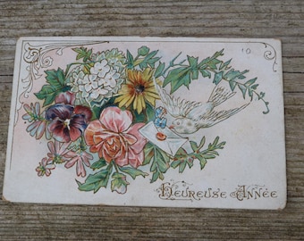 Vintage 1900  postcard figuring  flowers  and dove embossed written at the back