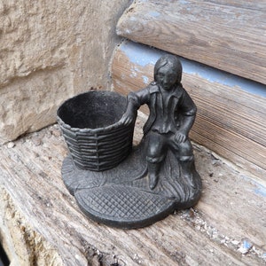 Vintage 1900 regule pyrogene match holder  figuring a man with basket