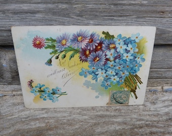 Cartão postal vintage de 1900 com buquê de flores "Não me esqueças" e mensagem escrita à mão