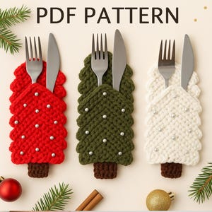 May include: Three crochet Christmas tree-shaped cutlery holders in red, green, and white, each holding a fork and knife. The trees are adorned with small, silver-colored beads. The text "PDF PATTERN" is at the top.