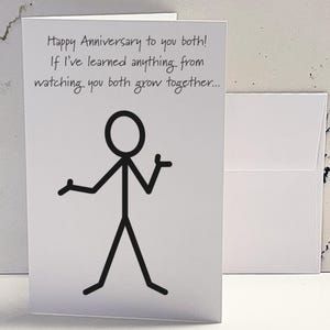 May include: A white card with black text that reads "Happy Anniversary to you both! If I've learned anything from watching you both grow together..." and a stick figure illustration.