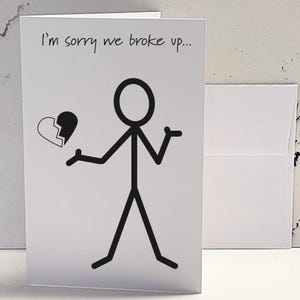 May include: A white card with the text "I'm sorry we broke up..." and a stick figure holding a broken heart.