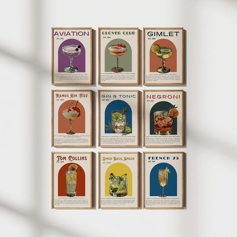 May include: Nine vintage-style posters featuring illustrations of different cocktails, each with a unique name and a retro-inspired design. The posters are framed in a light wood frame and have a cream background.