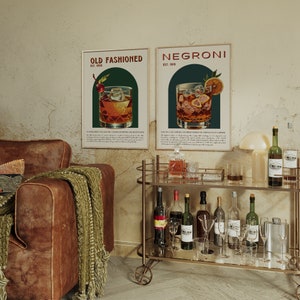 Elegant lounge with leather sofa, bar cart, and framed posters; a classic Negroni cocktail in a glass with ice and an orange slice and a classic Old Fashioned cocktail, garnished with an orange twist and cherry; featuring a chic, lived-in aesthetic