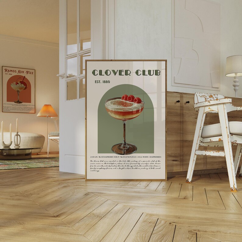 May include: A vintage-style poster for Clover Club, a bar established in 1880. The poster features a green background with a white archway and a glass of Clover Club cocktail garnished with raspberries. The text "Clover Club Est. 1880" is printed in a retro font.