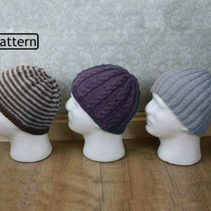 May include: Three knitted hats on display mannequins. The hats are in a striped pattern, a cable knit pattern, and a ribbed pattern. The hats are in brown and white, purple, and gray.