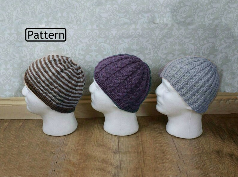 May include: Three knitted hats on display mannequins. The hats are in a striped pattern, a cable knit pattern, and a ribbed pattern. The hats are in brown and white, purple, and gray.