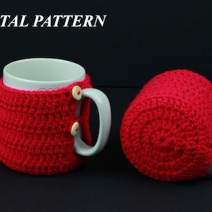 May include: Two red crocheted mug cozies with white buttons. The cozies are made with a simple stitch pattern and are perfect for keeping your hands warm while enjoying a hot beverage.