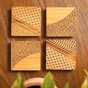 May include: Four square wooden coasters with intricate laser-cut geometric designs. The coasters are made of light brown wood and feature a variety of patterns, including squares, circles, and lines.