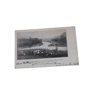 May include: A vintage black and white photograph of a river landscape during a flood. The photograph is labeled "Junction of Beaverkill and Willowemoc during flood, Roscoe, Sullivan County, N.Y." with handwritten text below.