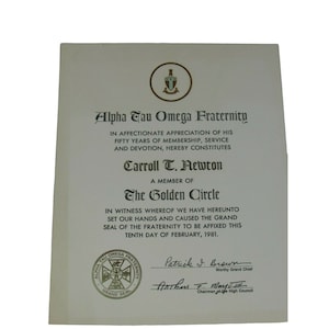 May include: A white certificate with gold lettering and a gold seal. The certificate is for Carroll T. Newton, a member of the Alpha Tau Omega Fraternity. The certificate states that he has been a member for 50 years and is being recognized for his service and devotion. The certificate is dated February 10, 1981.