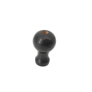 May include: A black wooden furniture knob with a round top and a cylindrical base. The knob has a small hole at the top. The knob is likely used for drawers, cabinets, or other furniture.