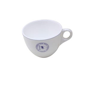 May include: White ceramic teacup with a blue and white logo that reads "The Caledonia Steam Packet Company Limited".