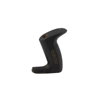 May include: A black, curved handle with the text "MILLERS FALLS MADE IN USA NO900" printed on the side. The handle has a hole at the top and a curved design for gripping. The handle is likely for a tool.